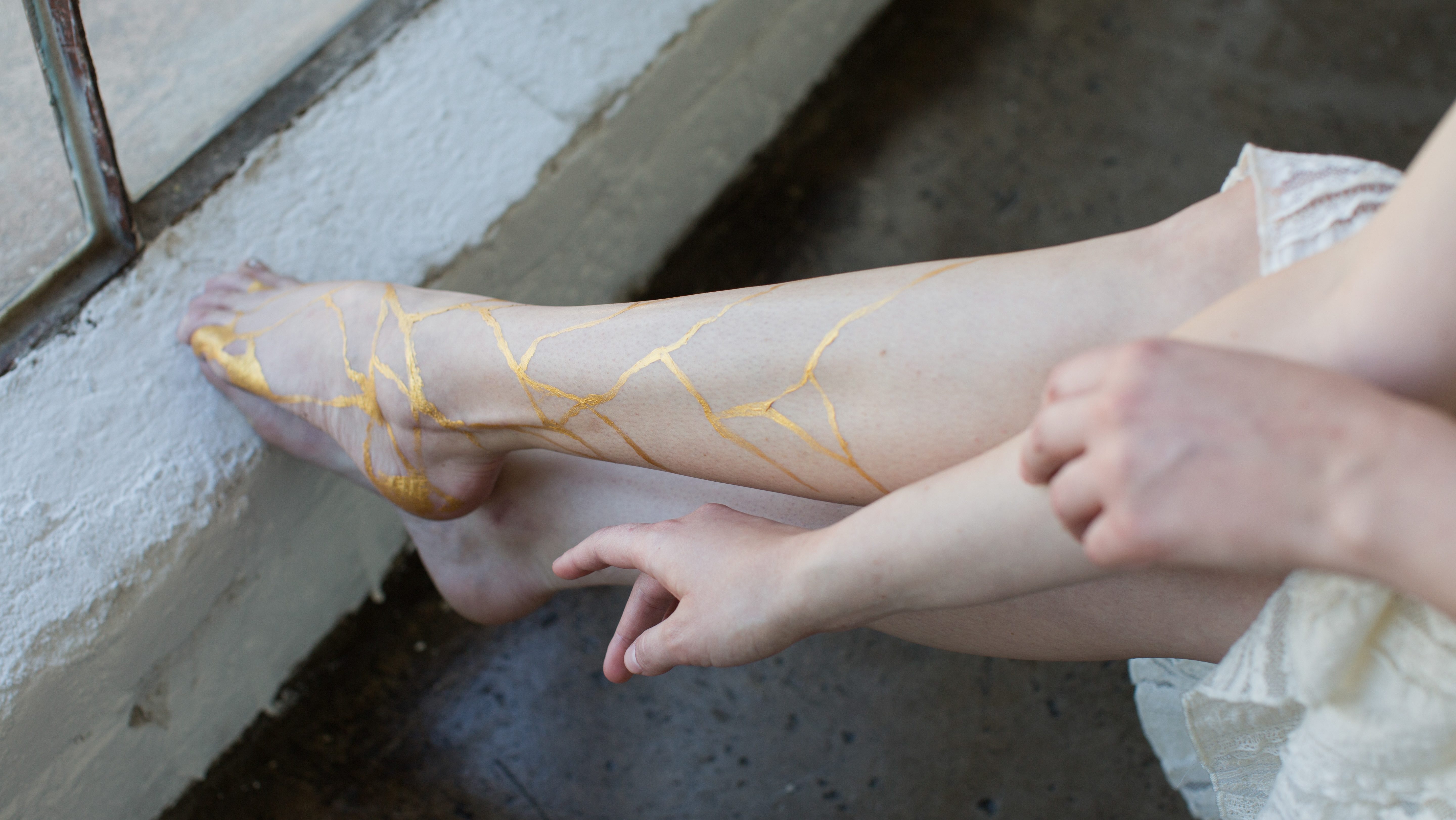 gold kintsugi lines on legs